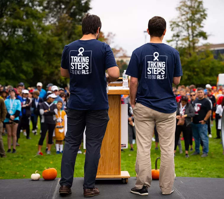 Amylyx co-CEOs Josh Cohen and Justin Klee addressing a crowd at an ALS community walk.